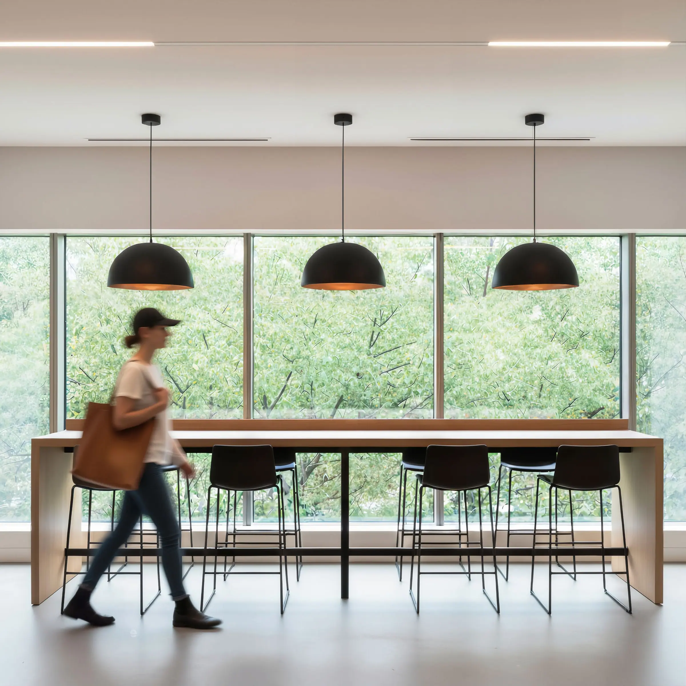 Rendering of the coworking space with a long table and windows onto the jungle