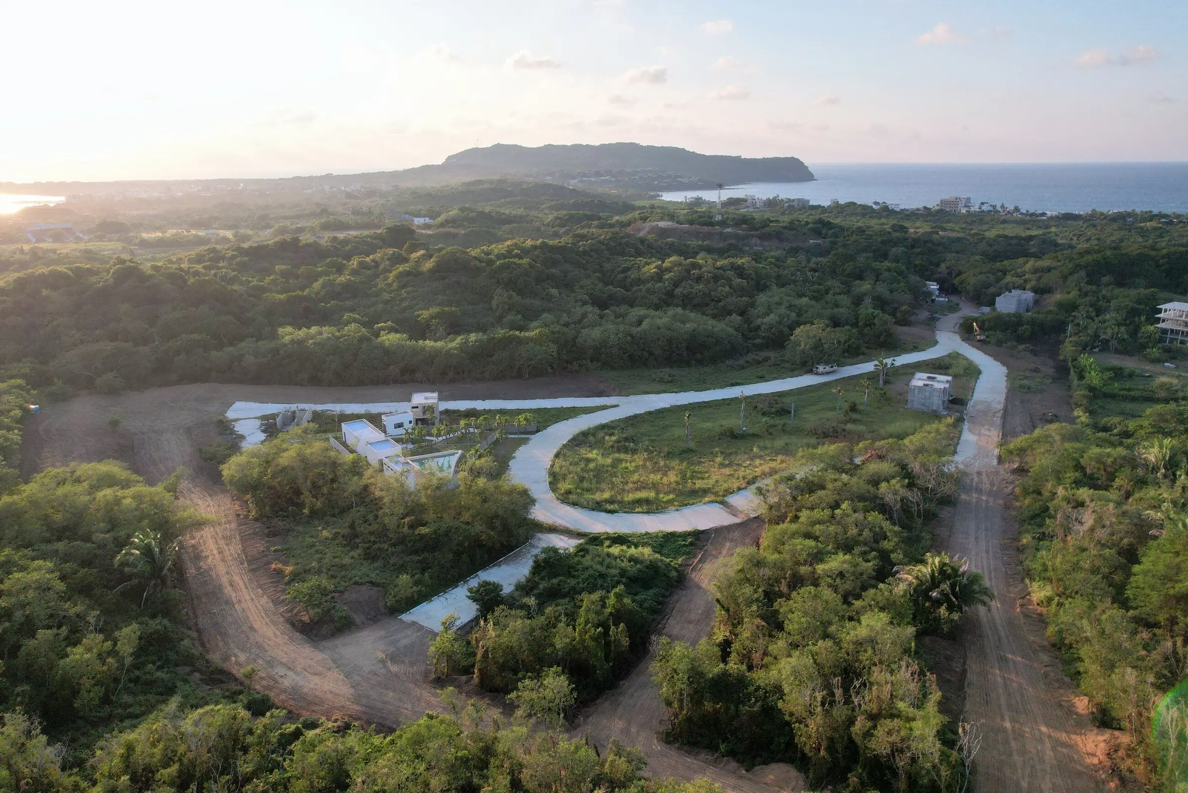 Real aerial photograph of Cumbres de Mita, its streets winding through the jungle with the ocean behind
